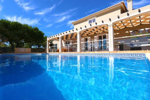 a large swimming pool in front of a building at Quinta do Pinheiro Manso - Holidays Villa - Marinha Beach in Carvoeiro