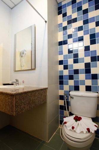 a bathroom with a toilet and a sink at U Sabai Living Hotel in Patong Beach