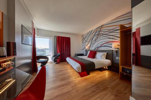 a hotel room with a bed and a large window at Sleeperz Hotel Dundee in Dundee