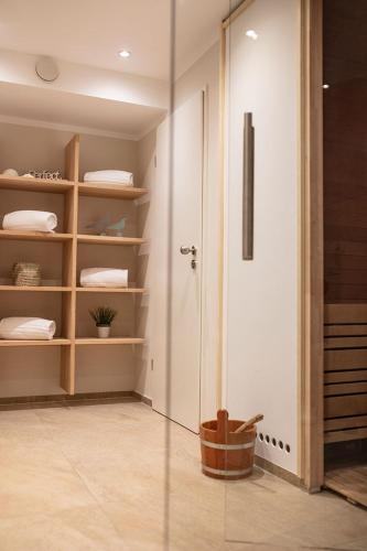 a room with a closet with a glass door at Hotel Bachmair Alpina in Rottach-Egern