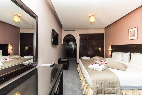 Postel nebo postele na pokoji v ubytování Hotel Almas