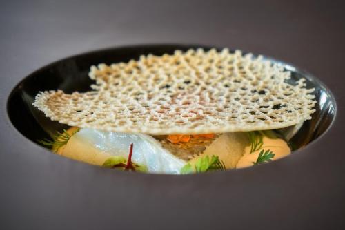a sandwich sitting in a black bowl with a sandwich at Relais Del Nazionale in Vernante