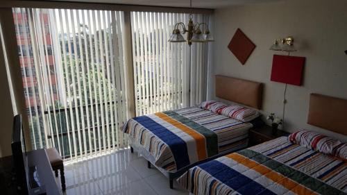Katil atau katil-katil dalam bilik di Apartment business/airport area Guatemala City