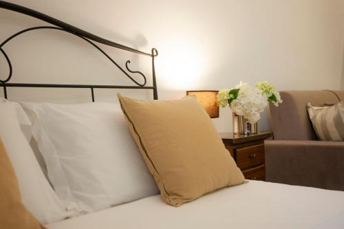 a bed with a yellow pillow on top of it at Il Carmine Dimora Storica in Erice