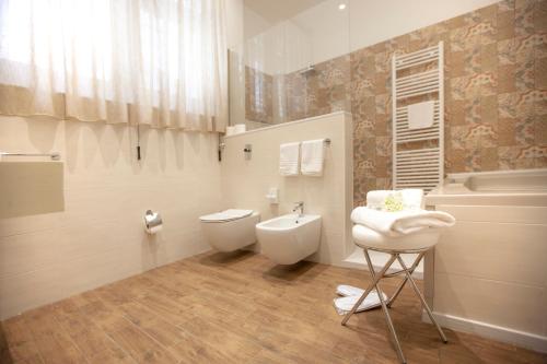a bathroom with a toilet and a bidet at Il Carmine Dimora Storica in Erice