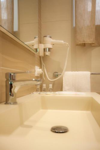 a bathroom with a tub and a sink and a mirror at Il Carmine Dimora Storica in Erice