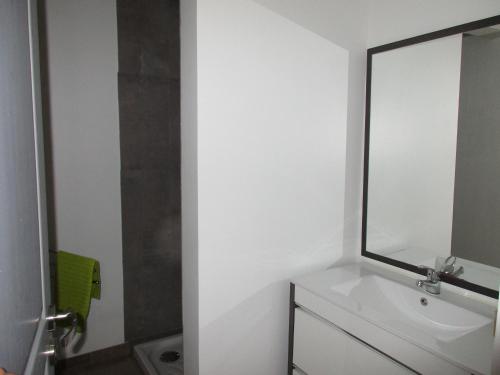 a bathroom with a sink and a mirror at Villabellevie in Bras-dʼAsse