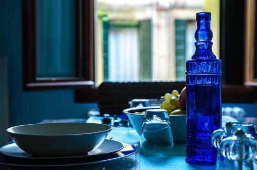 a blue bottle sitting on top of a table at Appartamento Azzurro Two Bathrooms in Venice