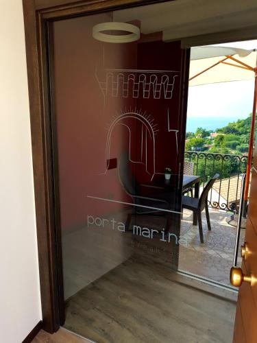 a glass door with a view of a table at B&B Porta Marina in Grottammare