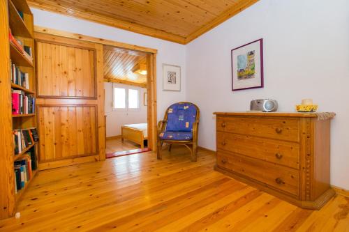 a room with a book shelf and a wooden dresser at Spiti Ena in Theologos