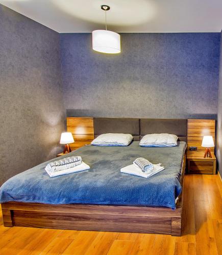 a bedroom with a bed with two towels on it at Area Park Bakuriani in Bakuriani