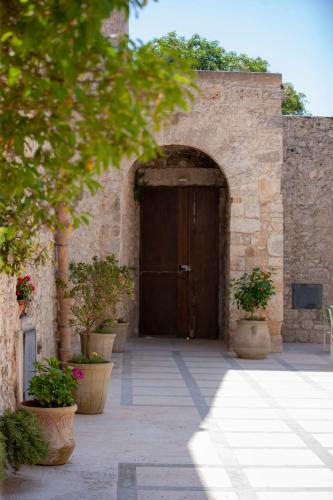 an entrance to a stone building with a wooden door at Il Carmine Dimora Storica in Erice