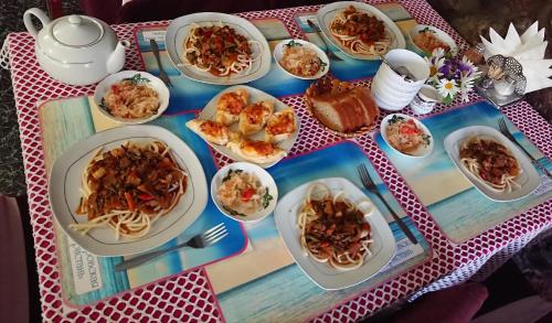 a table with plates of food on a table at Petrovskaya Pristan in Cholpon-Ata