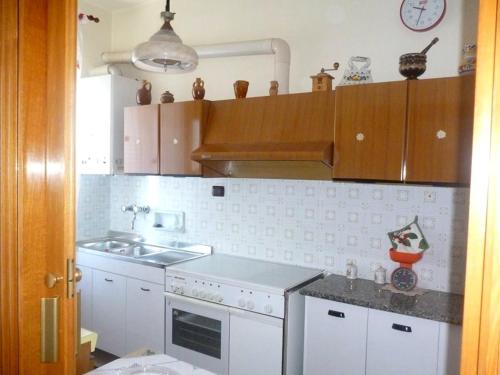 a kitchen with a sink and a stove top oven at Casa vacanza Manfredonia in Manfredonia