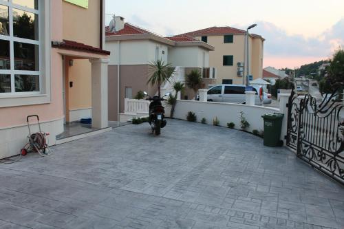 a motorcycle parked in a driveway next to a house at Villa Omazic in Trogir