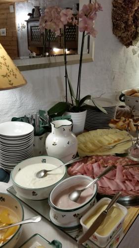 a table with dishes and spoons on top of it at B&B Elfi in Salzburg