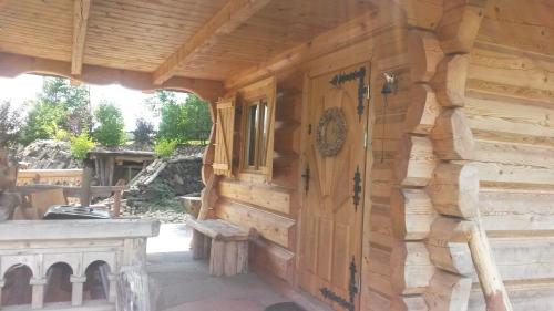 a log cabin with a wooden wall at Kaszubska Górska Chata in Bytów