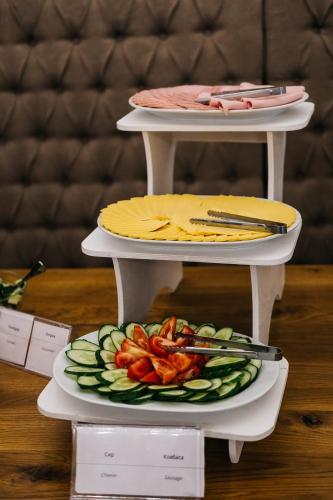 a table with two plates of food on a table at Hotel&Restaurant Premium Club in Yaremche