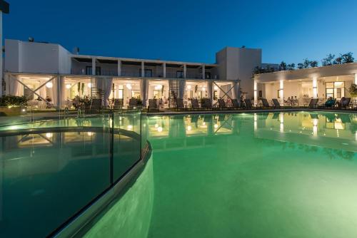 a swimming pool in front of a building at Aqua Bay in Plános