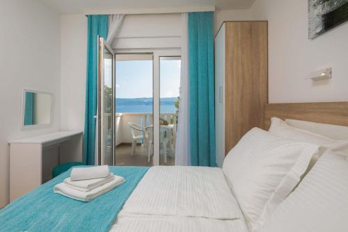 a bedroom with a bed with a view of the ocean at Villa Charlotte in Omiš