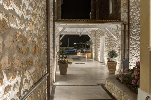 a hallway of a building with potted plants at Anemolia Parga Suites in Sarakiniko