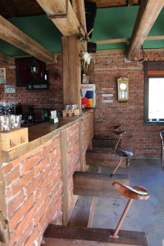 a room with a brick wall and a bar at Penzion Varšavjanka in Harrachov