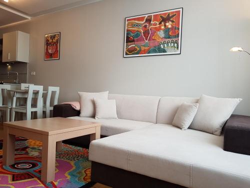 a living room with a couch and a table at Apartament 316 w Domu Zdrojowym in Jastarnia