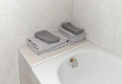 a bathroom with towels sitting on a bath tub at Bauernhof Madlener Claudia in Schoppernau
