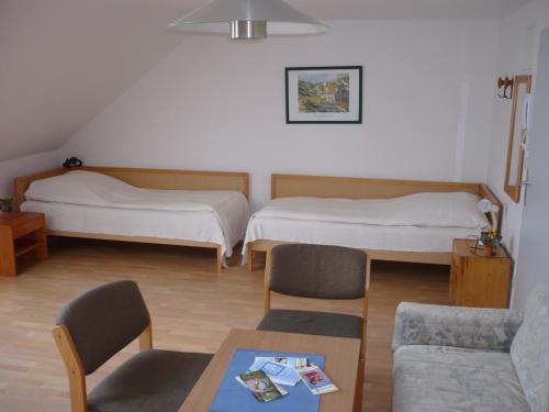 a living room with two beds and a couch at Haus Marinus in Puttgarden