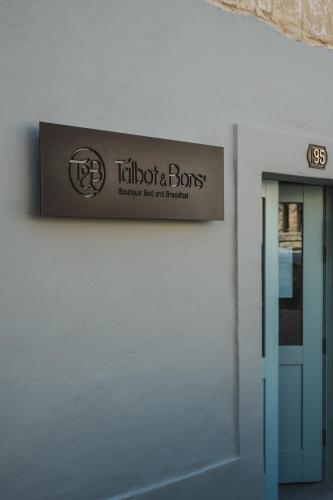 a sign on the side of a building at Talbot & Bons Bed & Breakfast in Gudja