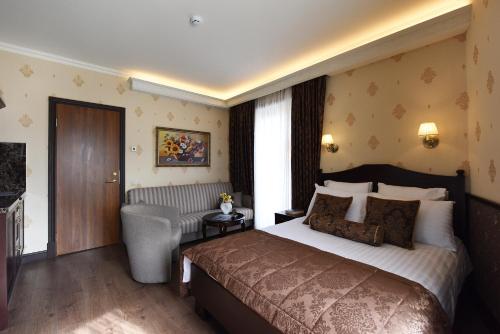 a hotel room with a bed and a chair at KEY for REST in Palanga