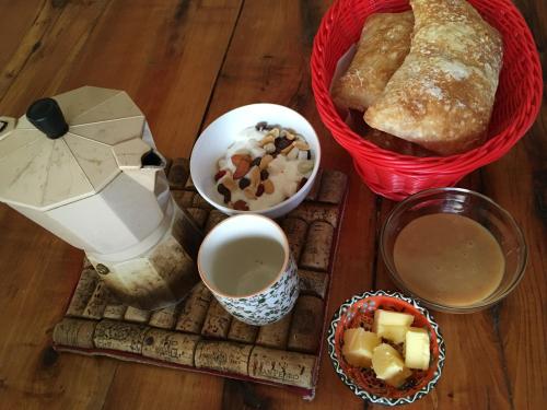 a table topped with bread and other food and drinks at Eco-Cabañas Quetroleufu in Pucón