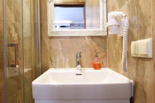 a bathroom with a white sink and a mirror at KEY for REST in Palanga