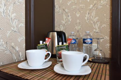 two white cups on a table with water bottles at KEY for REST in Palanga