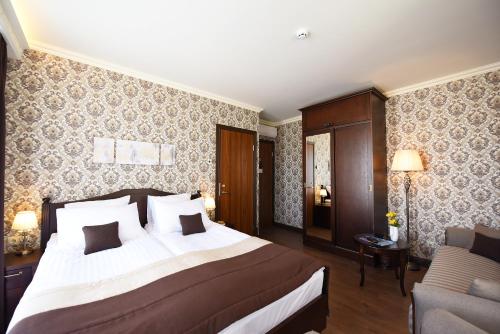 a hotel room with a bed and a couch at KEY for REST in Palanga