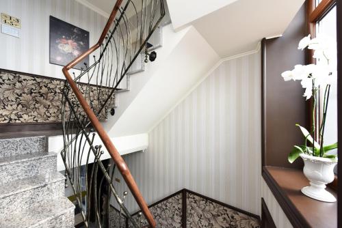 a winding staircase in a home with white walls at KEY for REST in Palanga