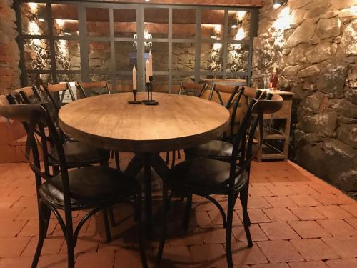 a wooden table with chairs and a candle on top at Pension Angusfarm in Soběsuky