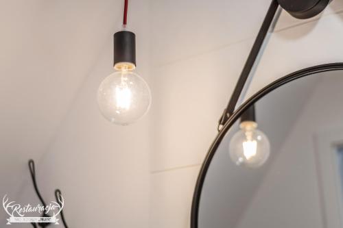 a couple of lights hanging on a wall at Pokoje hotelowe Nad jeziorem Jelen in Bytów