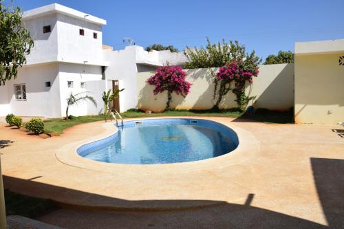 a swimming pool in the yard of a house at Villa Du Soleil Ngaparou in Ngaparou