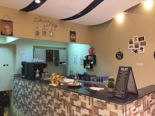 a bar in a restaurant with a counter top at Wahat Al Yarmouk Serviced Apartments in Ţubarjal