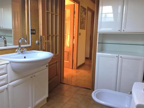 a bathroom with a sink and a toilet at Appartamento Gorgotto in Gravedona