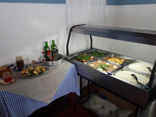 a table with two trays of food and drinks on it at Hotel Planalto in Poços de Caldas