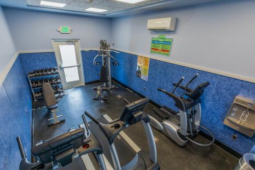 a gym with three treadmills and cardio machines at Shutters on the Banks in Kill Devil Hills