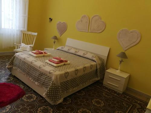 a bedroom with a bed with hearts on the wall at Appartamento cuore al centro di Taranto in Taranto