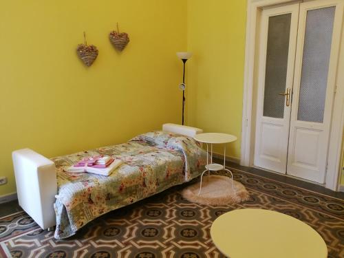 a bedroom with a bed with shoes on it at Appartamento cuore al centro di Taranto in Taranto