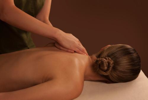 a woman getting a back massage from a therapist at No.1 Pery Square Hotel & Spa in Limerick