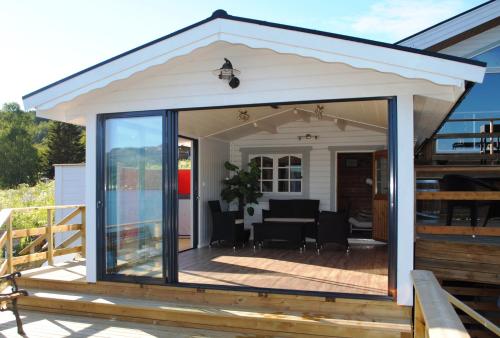 a patio extension with glass doors on a deck at Furoy Hotel Apartments and Boating in Sorreisa