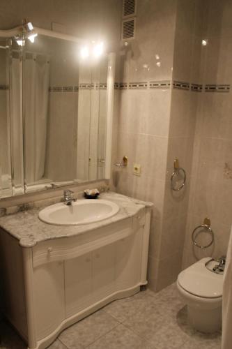 a bathroom with a sink and a toilet at Casa Miguel in La Portellada