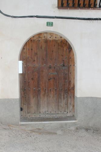 a wooden door in the side of a building at Casa Miguel in La Portellada