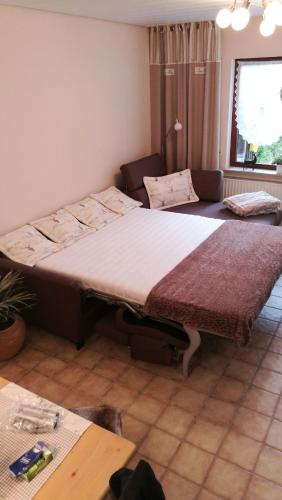 two beds sitting in a room with a table at Feriendomizil-Sauerland FeWo 2 in Medebach